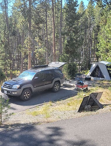 a toyota 4 runner at a campsite with a kodiak canvas flex bow tent and an ecoflow solar panel, unpacked while car camping in the sawtooth mountians.