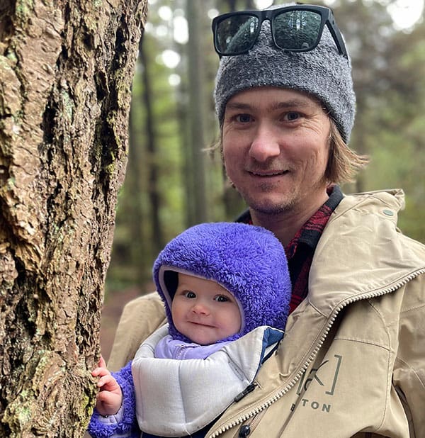 steve andrews and his daughter next to a tree