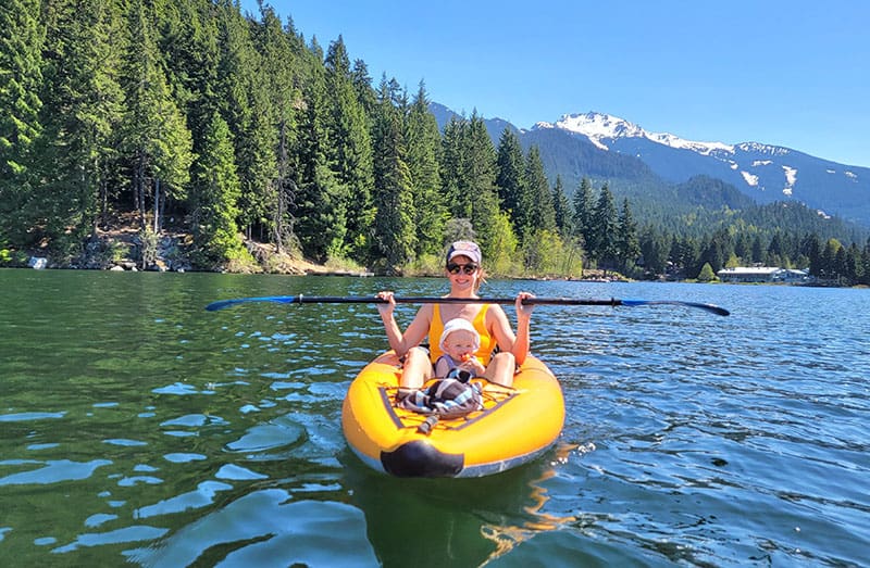 a woman and her baby kayaking on alta lake in Whistler, BC