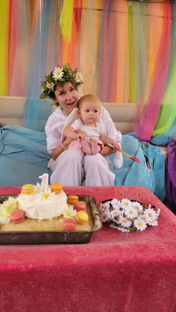 a mother and daughter celebrating the baby's first birthday at burning man