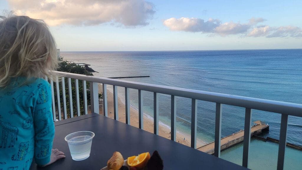 looking out on the balcony toward the ocean from the deck at the coconut club at the twin fin hotel in waikiki