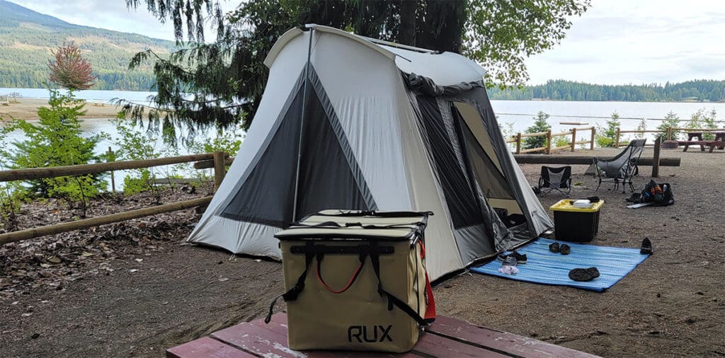 a kodiak tent in a campground next to a lake