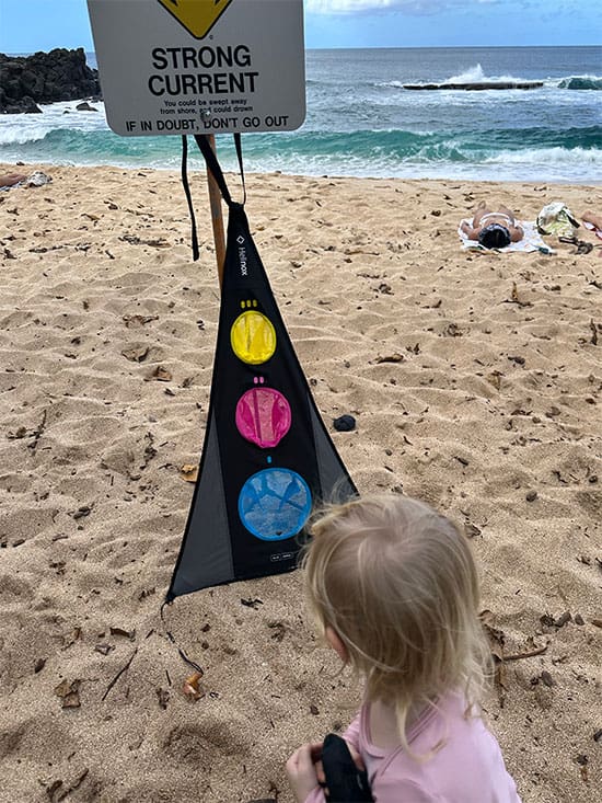 a young girl plays helidrop by helinox on the beach in hawaii