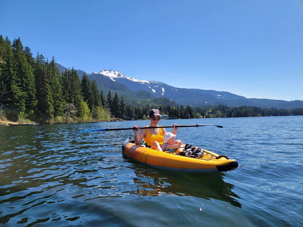 a mother and daughter kayak on alta lake in whistler, british columbia
