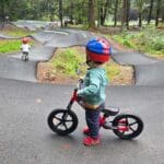 a young child looks onto the pump track