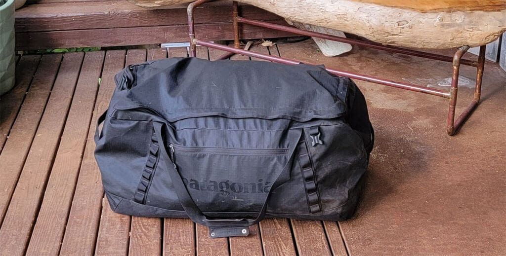 a patagonia black hole duffel bag fully loaded for the beach
