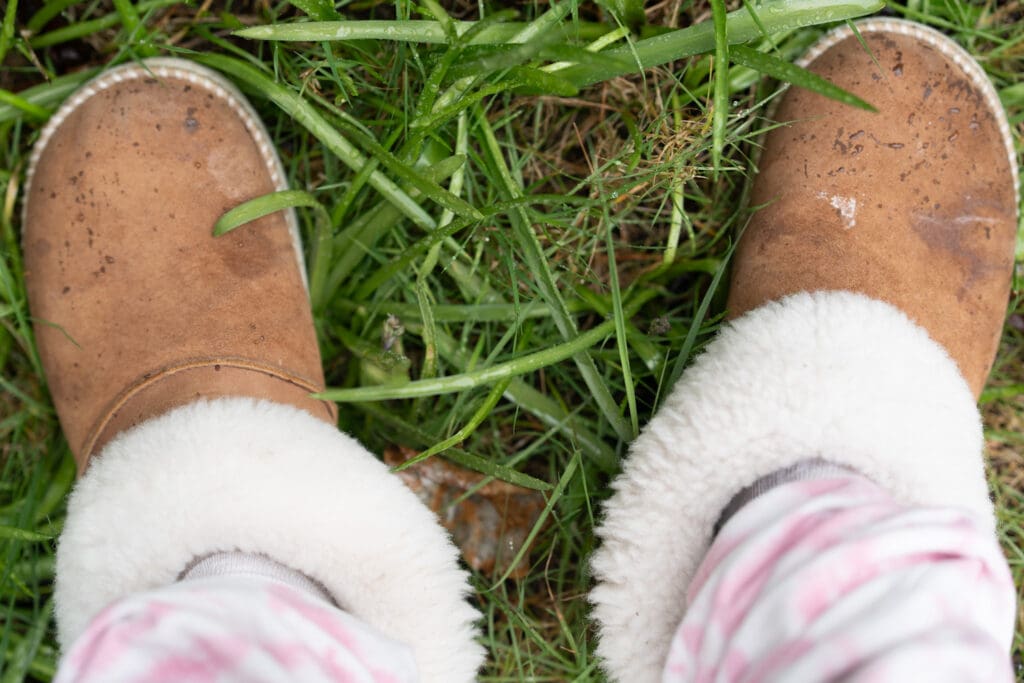 the olukai ku'i slippers being tested outside in the grass