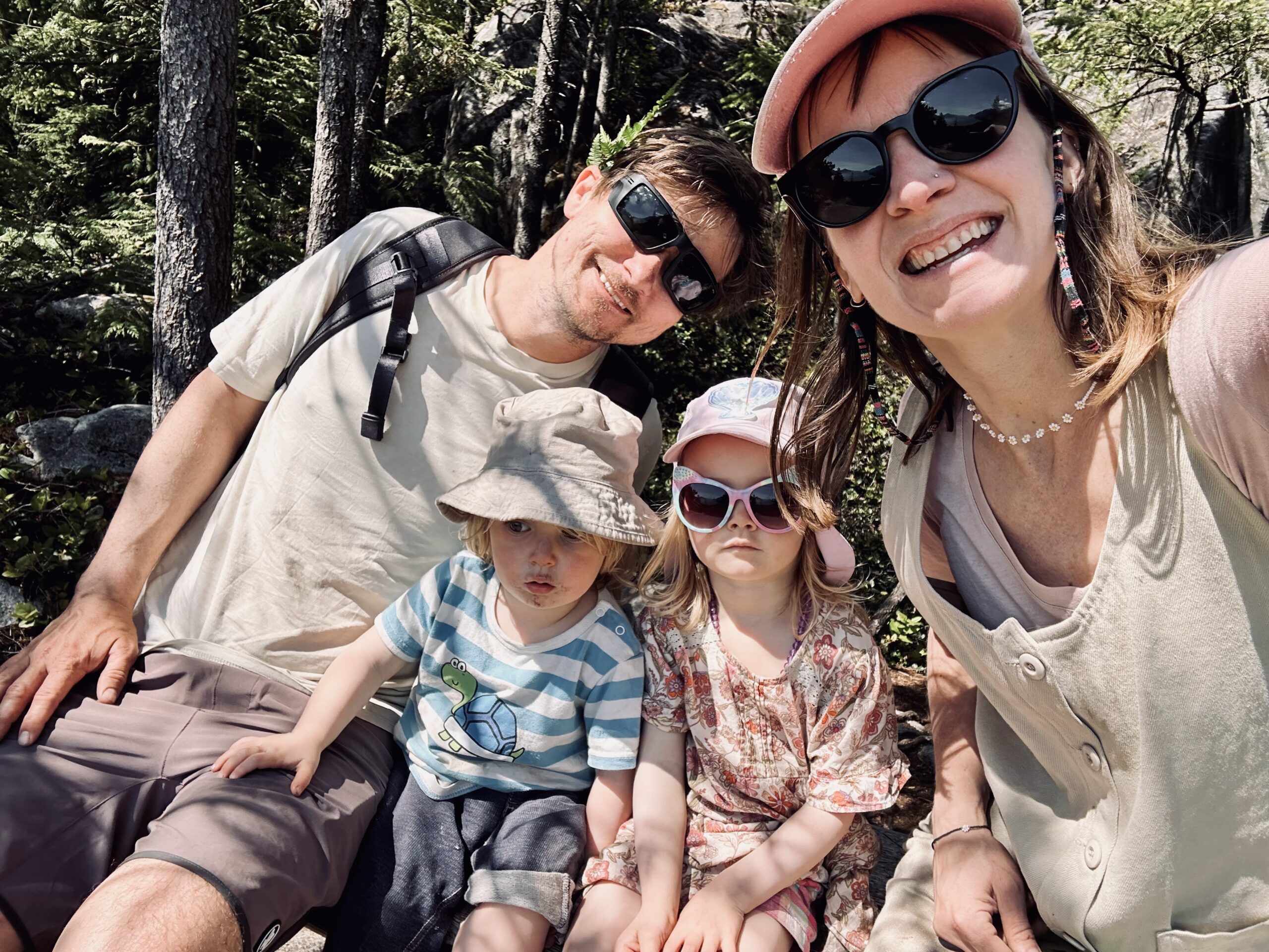 Family of four stopping for a pic on a hike