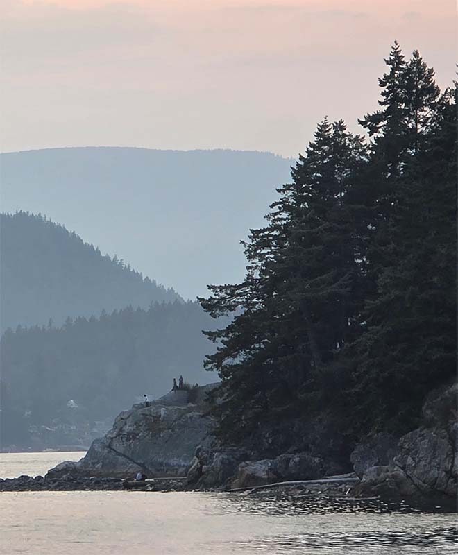 a telephoto view of the beach at Whytecliff park with bowen island in the background