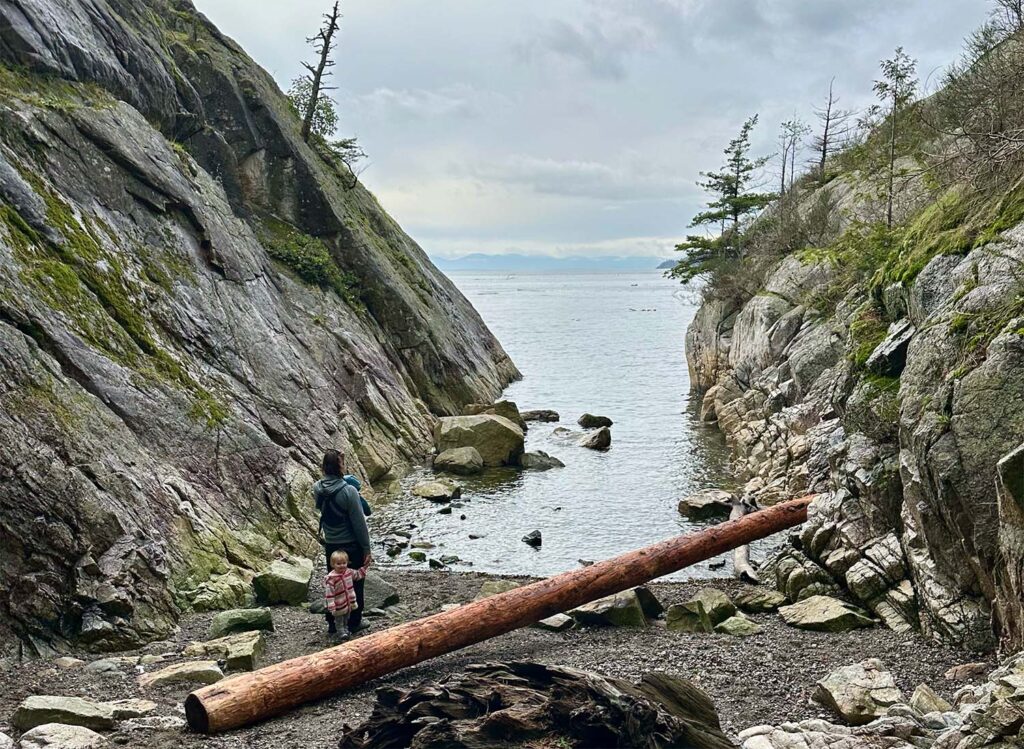 a father and daughter explore the coastline of british columbia at whytecliff park