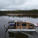 A Voyageur Houseboat cruising on the Winnepeg River