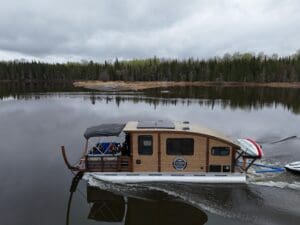 A Voyageur Houseboat cruising on the Winnepeg River