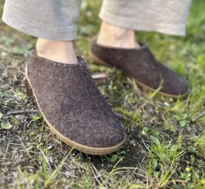 a pair of glerups low cut slippers with rubber sols in the grass
