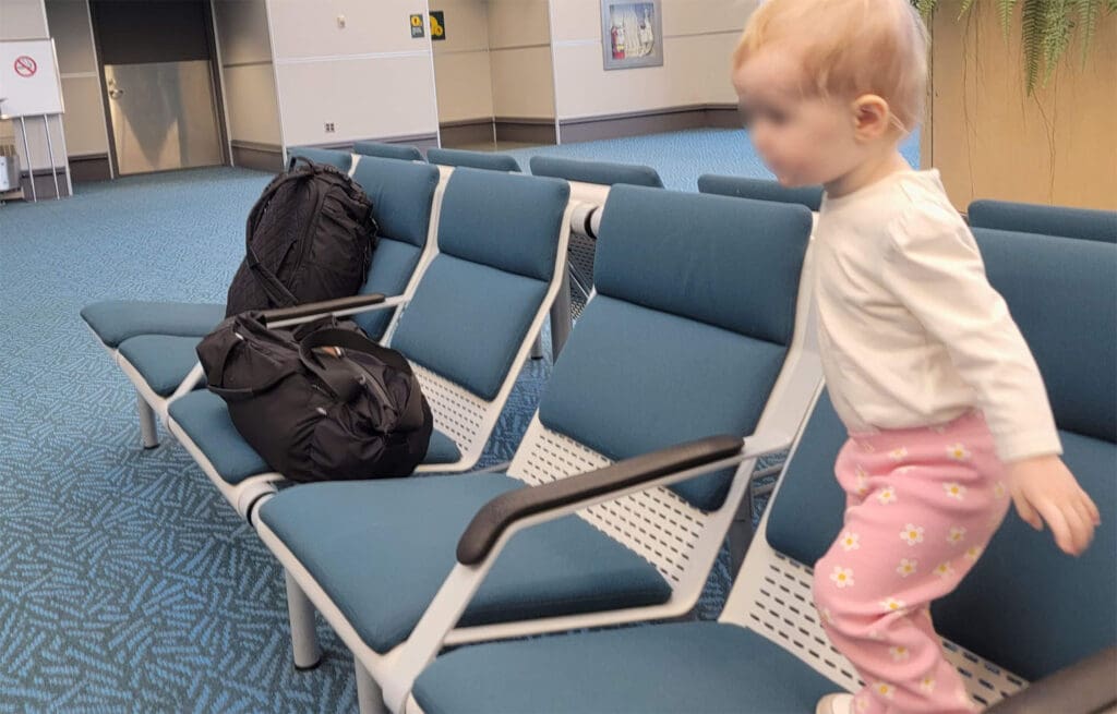 a child plays on airport seats while waiting for a flight