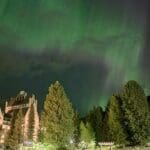 the northern lights shining above the fairmont chateau whistler