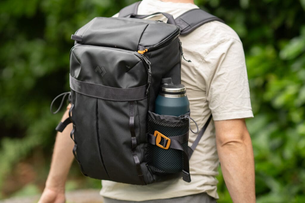 a man wearing the dometic unrestricted backpack cooler