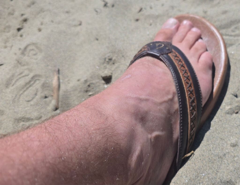 the olukai mea ola nu'u sandals in the sand